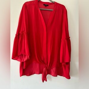 So pretty top with ruffles on sleeves and tie at bottom